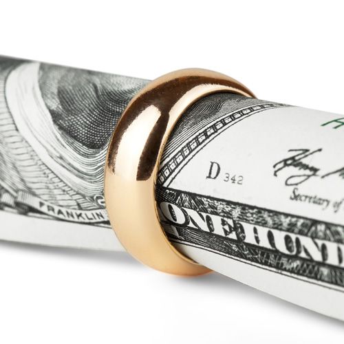 wedding ring with rooled up dollar in it